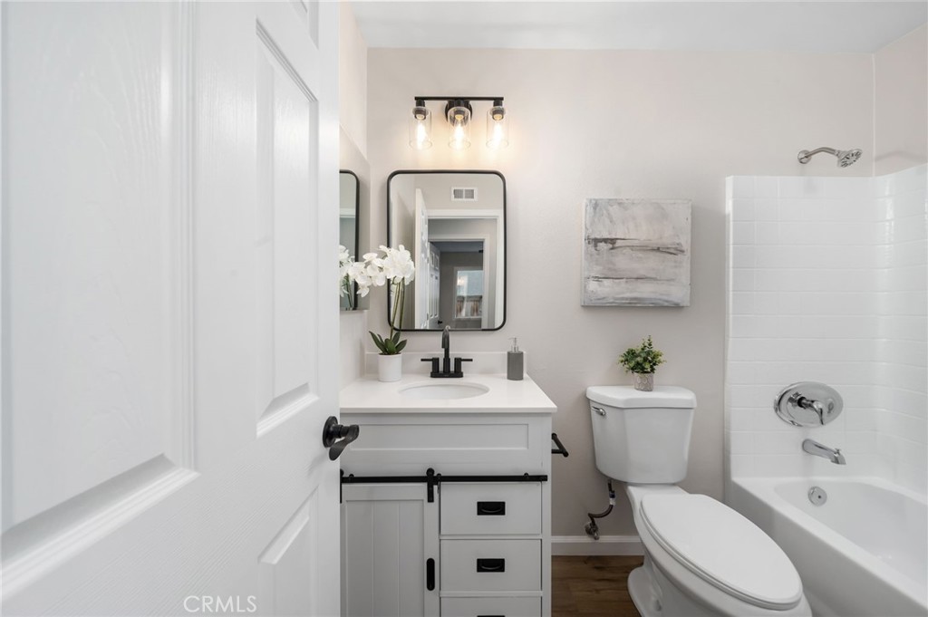 31577 Via Santa Ines Temecula, CA 92592 - Photo 33 of 49 a bathroom with a toilet sink vanity tub and mirror