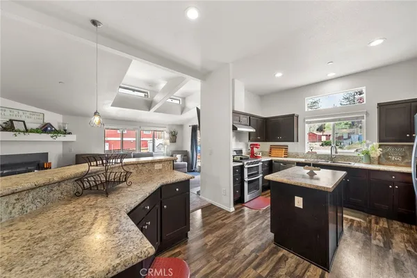 a kitchen with a sink stove and refrigerator