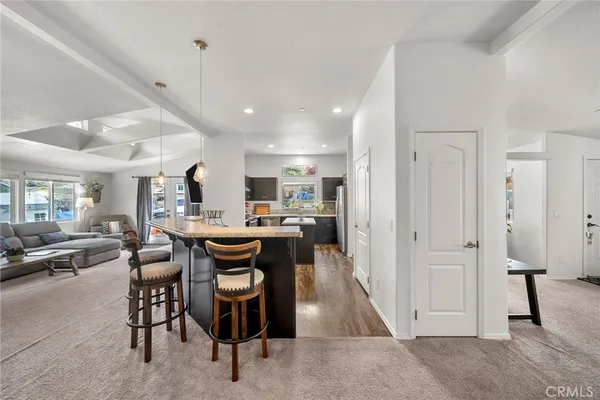 a living room with lots of furniture and kitchen view