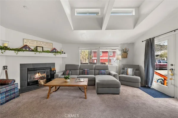 a living room with furniture and fireplace