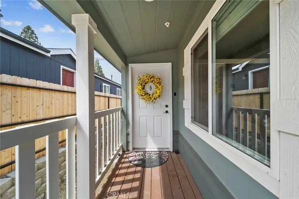 a living room with furniture flowers and a potted plant