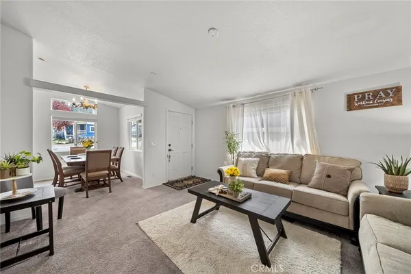 a dining room with furniture a chandelier and wooden floor