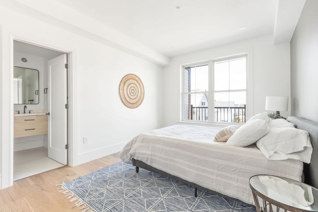 230 Washington Street, Unit 4 Boston, MA 02135 - Photo 5 of 13 a bedroom with a bed and a window