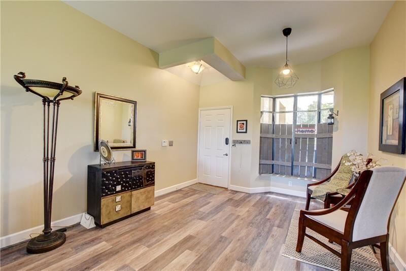 7448 La Paz Boulevard, Unit 104 Boca Raton, FL 33433 - Photo 9 of 16 a living room with furniture and a chandelier