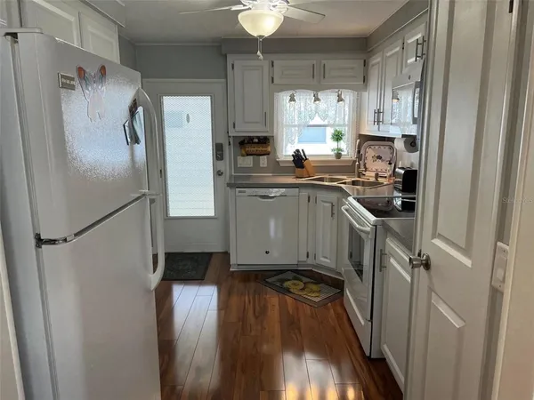 a kitchen with a refrigerator a sink and cabinets