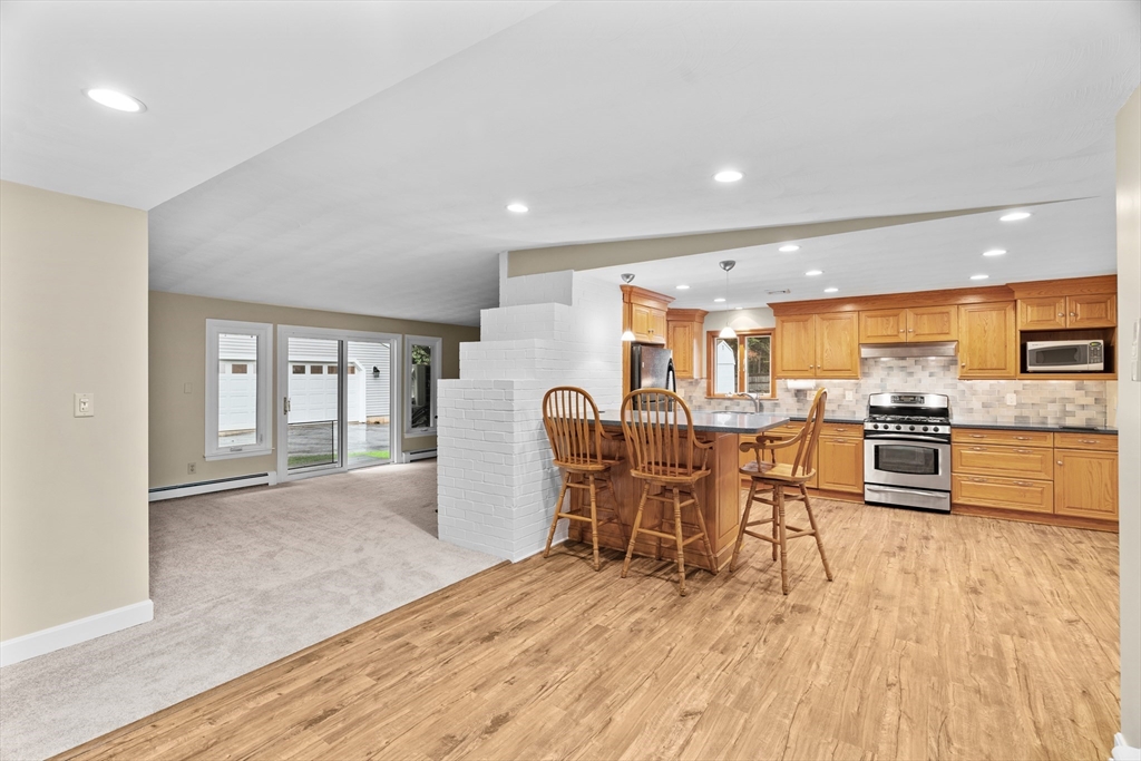 55 Eaton Road Framingham, MA 01701 - Photo 7 of 42 a view of a kitchen with furniture and wooden floor