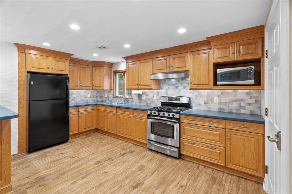 55 Eaton Road Framingham, MA 01701 - Photo 8 of 42 a kitchen with granite countertop a refrigerator stove top oven and sink