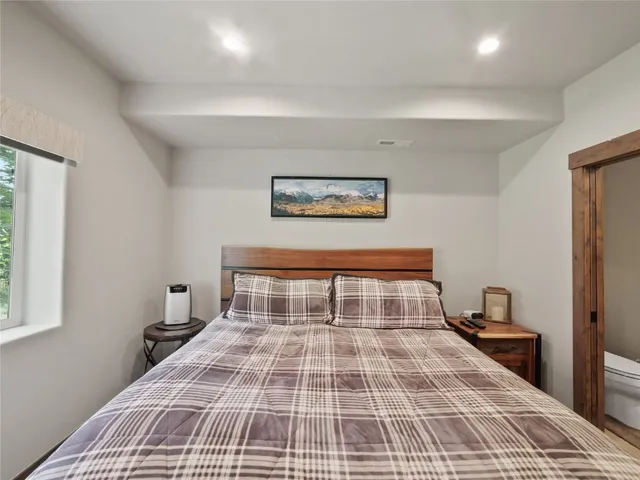 a bedroom with a bed and a window