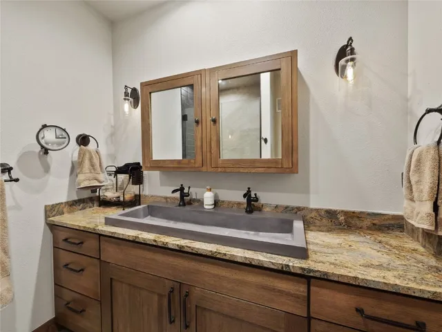 a bathroom with a sink and a mirror