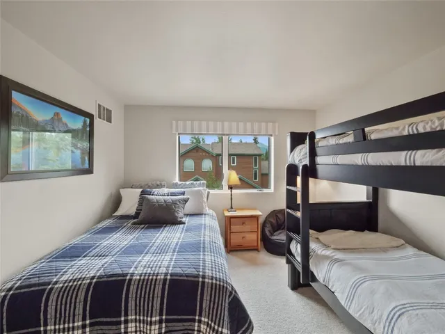 a bedroom with a large bed and a balcony