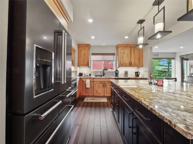 a kitchen with counter top space a sink appliances and cabinets