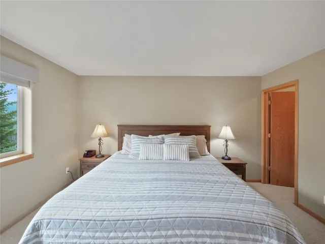 a bedroom with a bed and a night stand