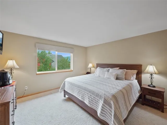 a bedroom with a bed lamp and window