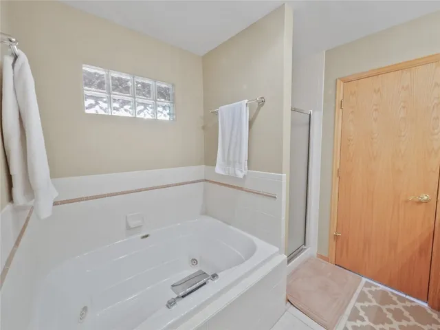 a white bath tub sitting next to a window