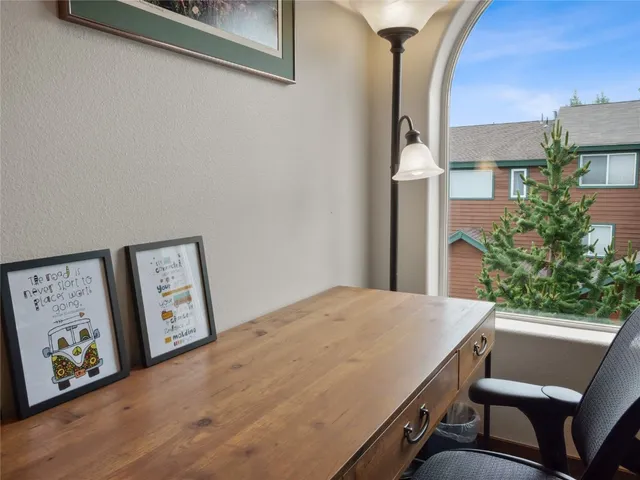 a view of a room with painting on the wall