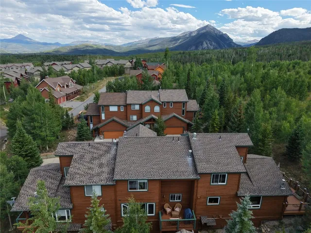 an aerial view of a house with a yard garage and lake view
