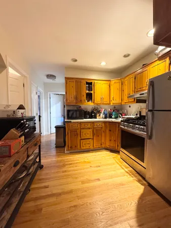 a kitchen with granite countertop stainless steel appliances and wooden cabinets