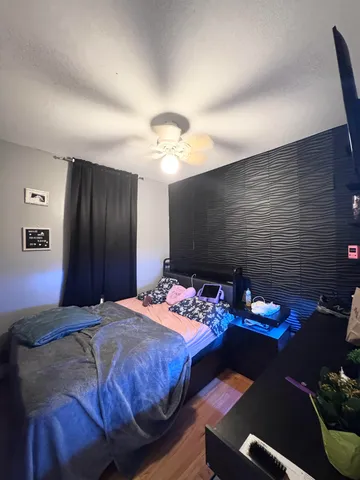 a bedroom with a bed and a chandelier