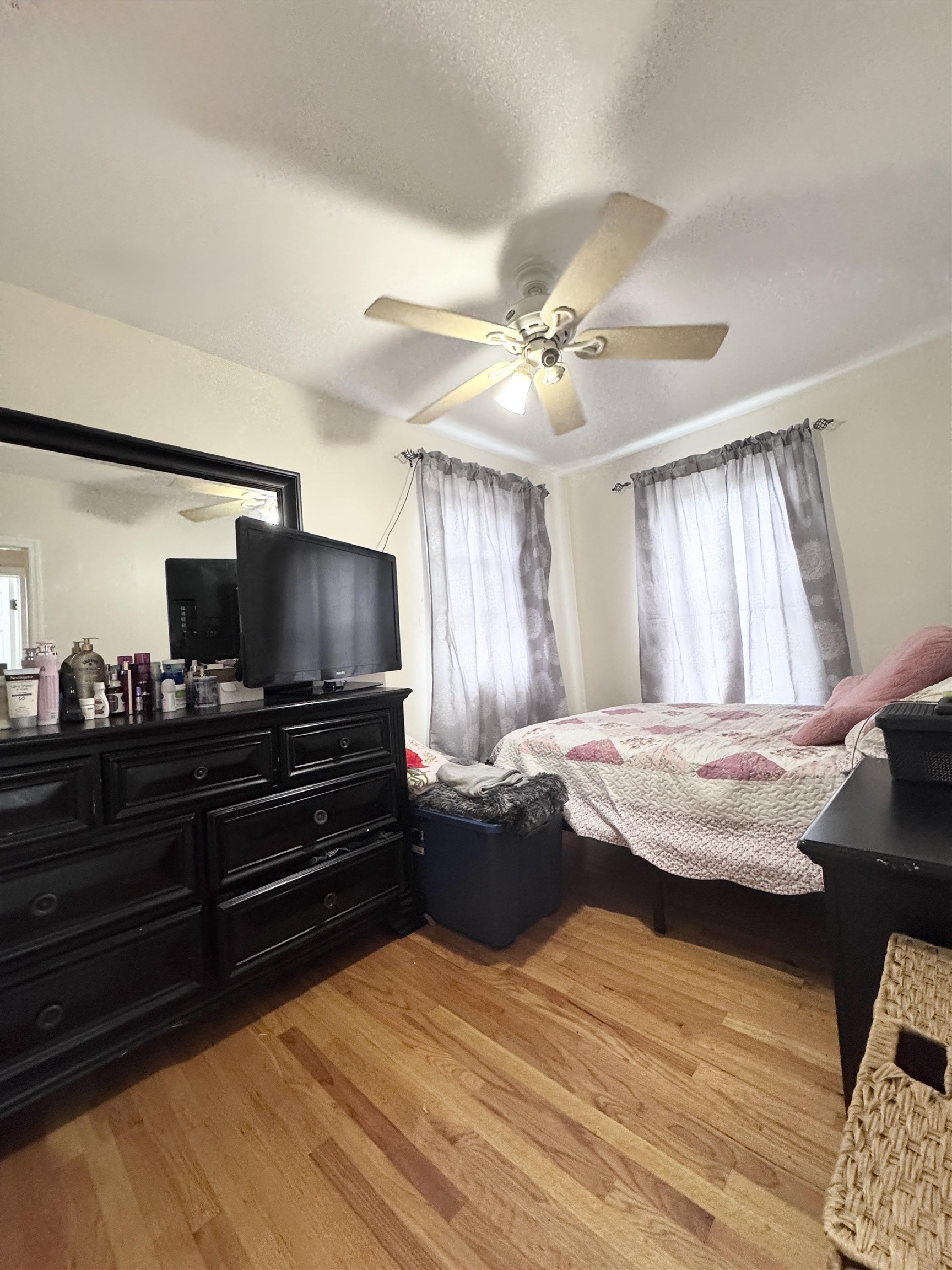 17 Green Court Lodi, NJ 07644 - Photo 16 of 21 a bedroom with a bed and a chandelier