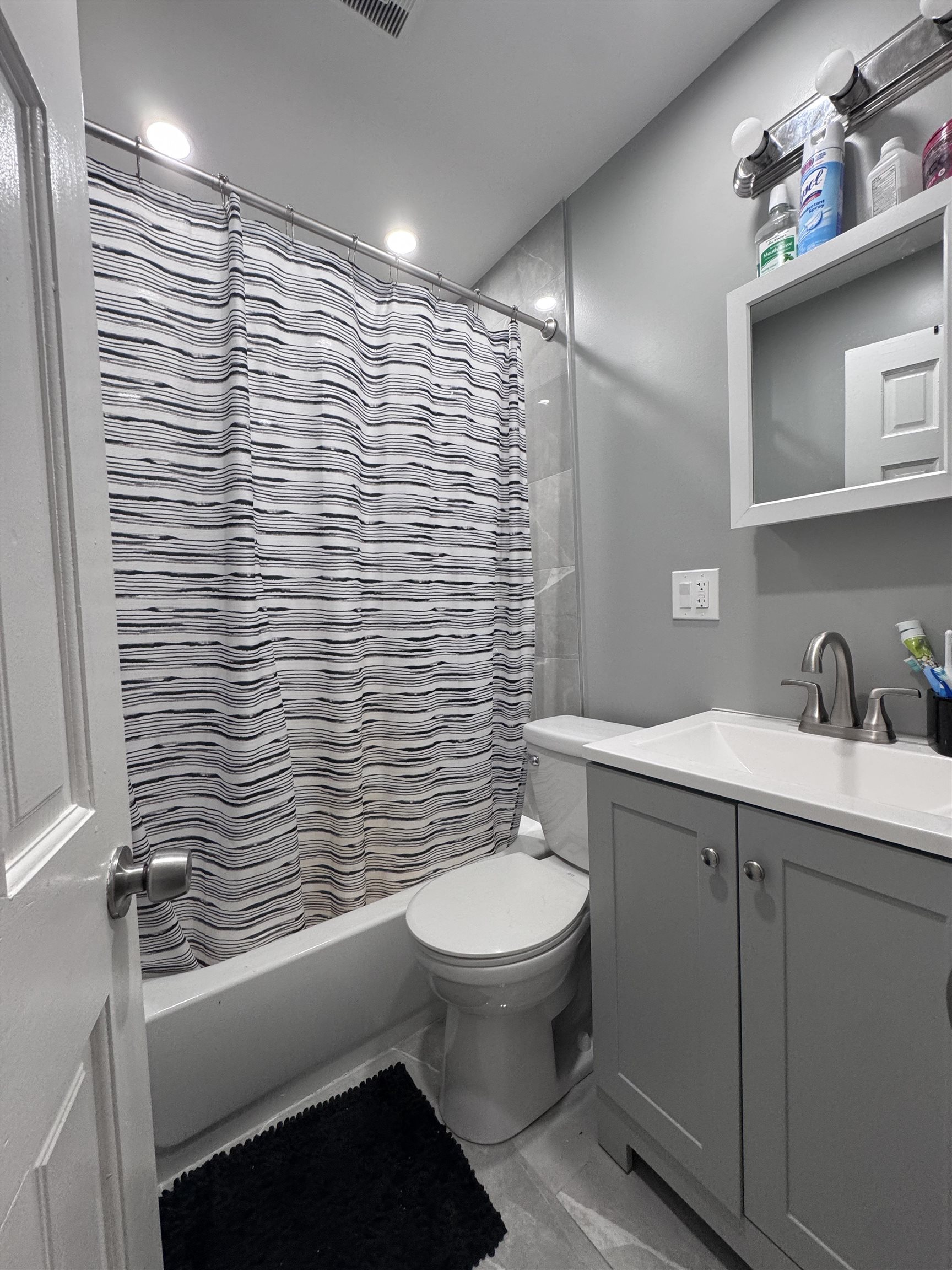 17 Green Court Lodi, NJ 07644 - Photo 17 of 21 a bathroom with a toilet a sink and mirror
