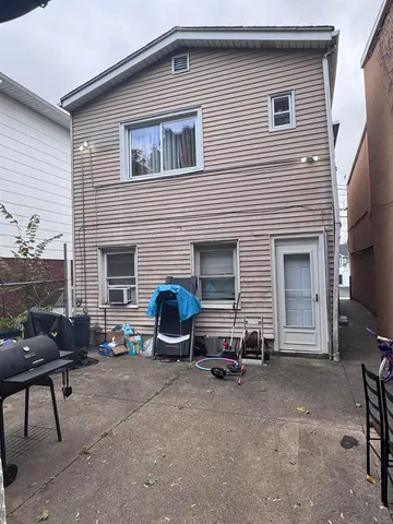 a view of backyard with outdoor seating and plants