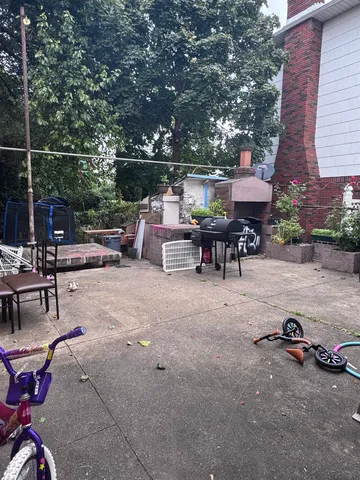 a view of a patio with a table and chairs under an umbrella