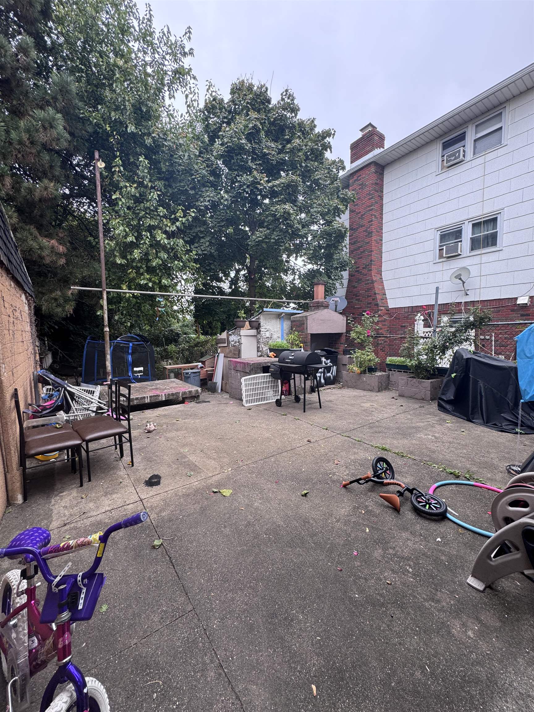 17 Green Court Lodi, NJ 07644 - Photo 20 of 21 a view of a patio with a table and chairs under an umbrella