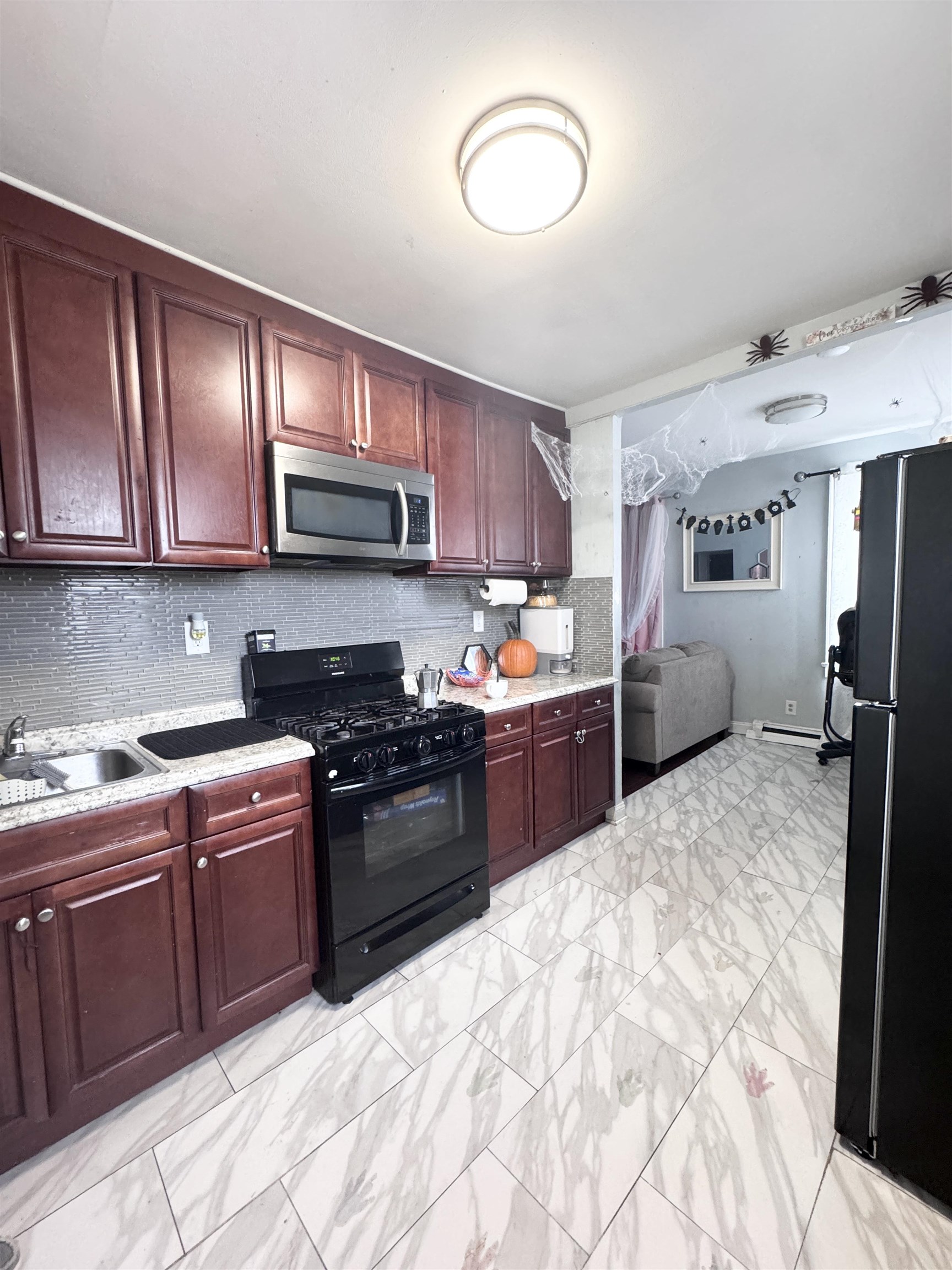 17 Green Court Lodi, NJ 07644 - Photo 3 of 21 a kitchen with stainless steel appliances granite countertop a stove sink and cabinets