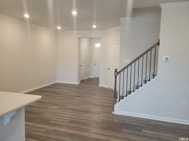 a view of a hallway with wooden floor