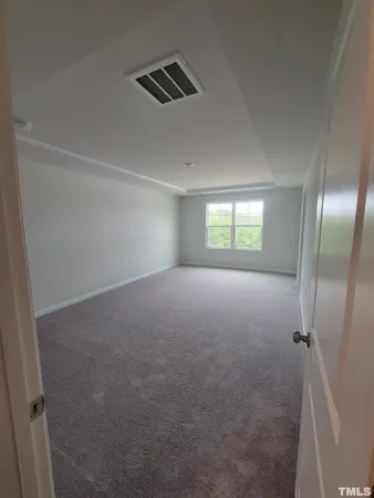 an empty room with an entrance to other room