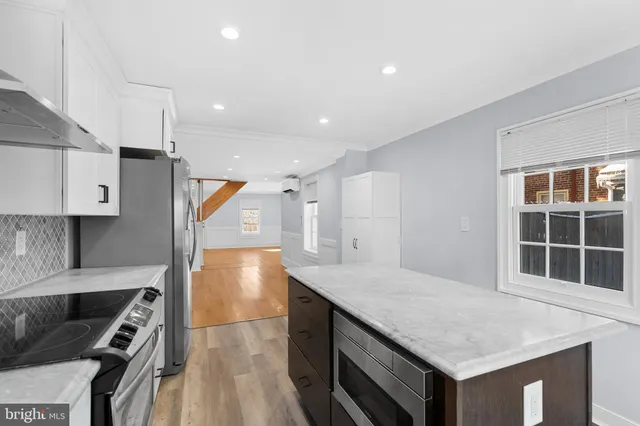 a kitchen with stainless steel appliances granite countertop a stove and a sink