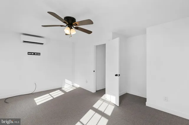 a view of a livingroom with a ceiling fan and window