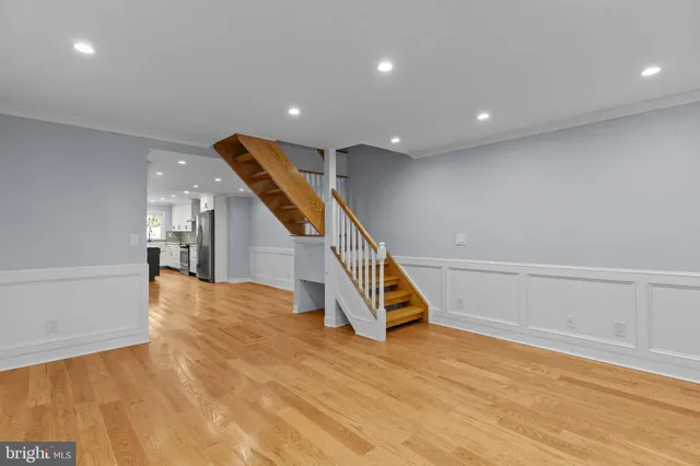 a view of entryway and hall with wooden floor