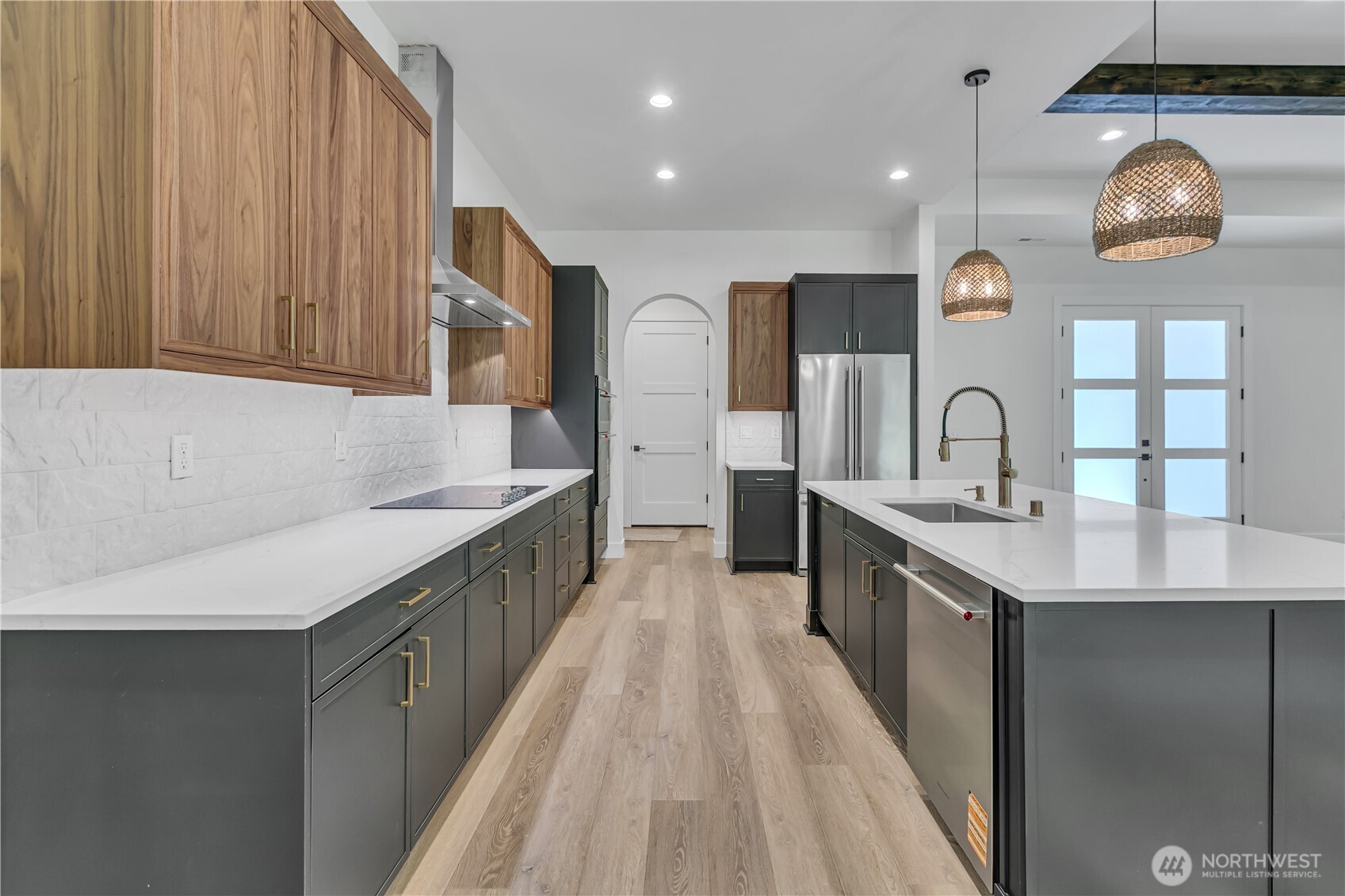 6709 254th Street East Graham, WA 98338 - Photo 12 of 40 a large kitchen with a large counter top a sink a stove and stainless steel appliances