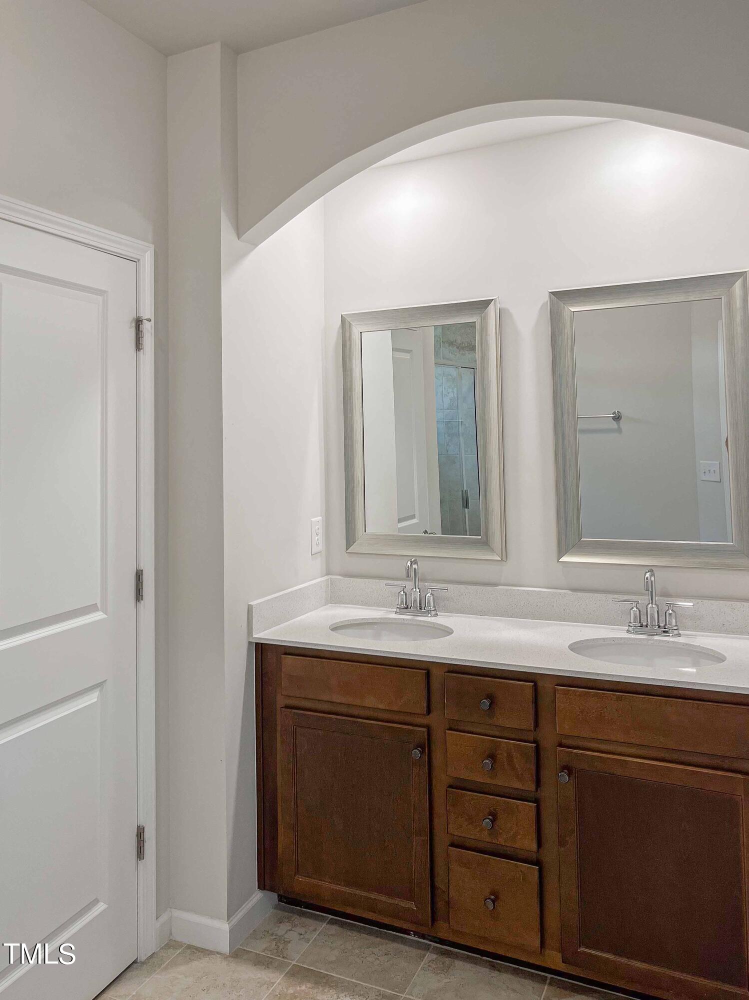 6027 Beale Loop Raleigh, NC 27616 - Photo 12 of 21 a bathroom with a double vanity sink and a mirror