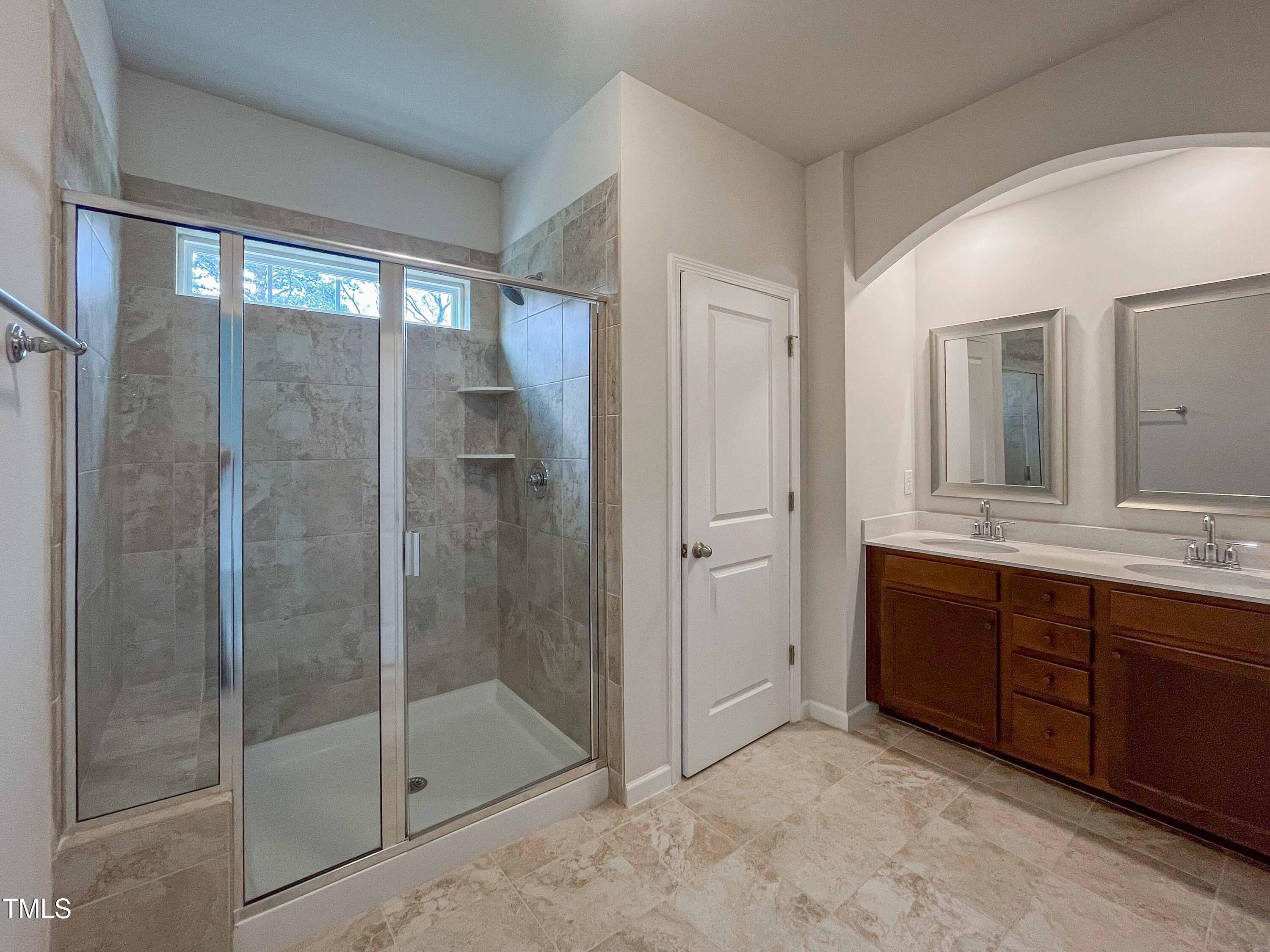 6027 Beale Loop Raleigh, NC 27616 - Photo 13 of 21 a bathroom with a shower and a sink mirror