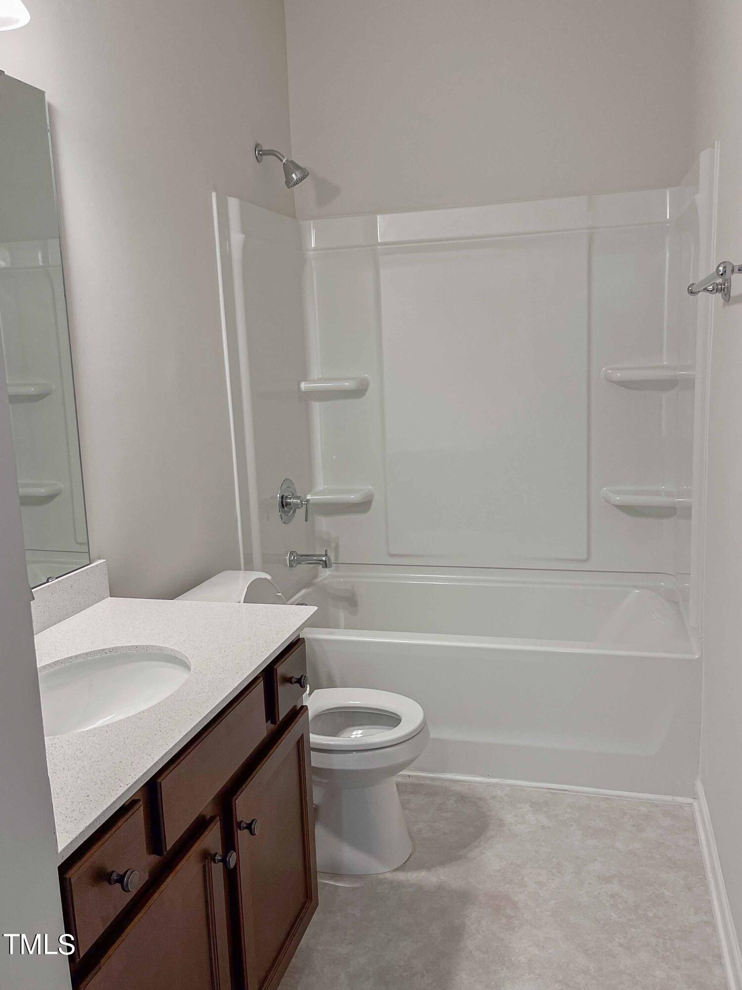 6027 Beale Loop Raleigh, NC 27616 - Photo 15 of 21 a bathroom with a sink a toilet and shower