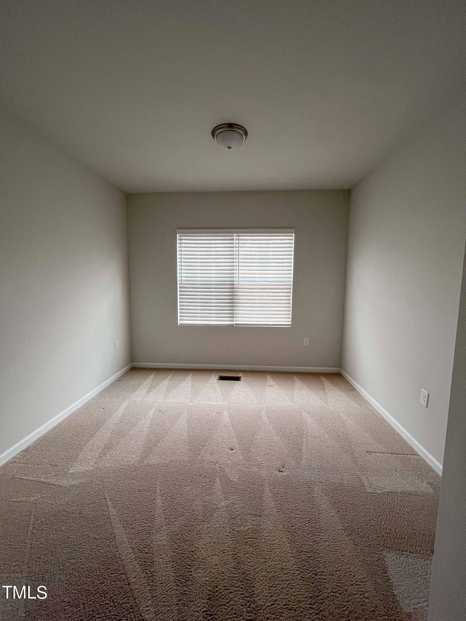 6027 Beale Loop Raleigh, NC 27616 - Photo 17 of 21 an empty room with a empty space and windows