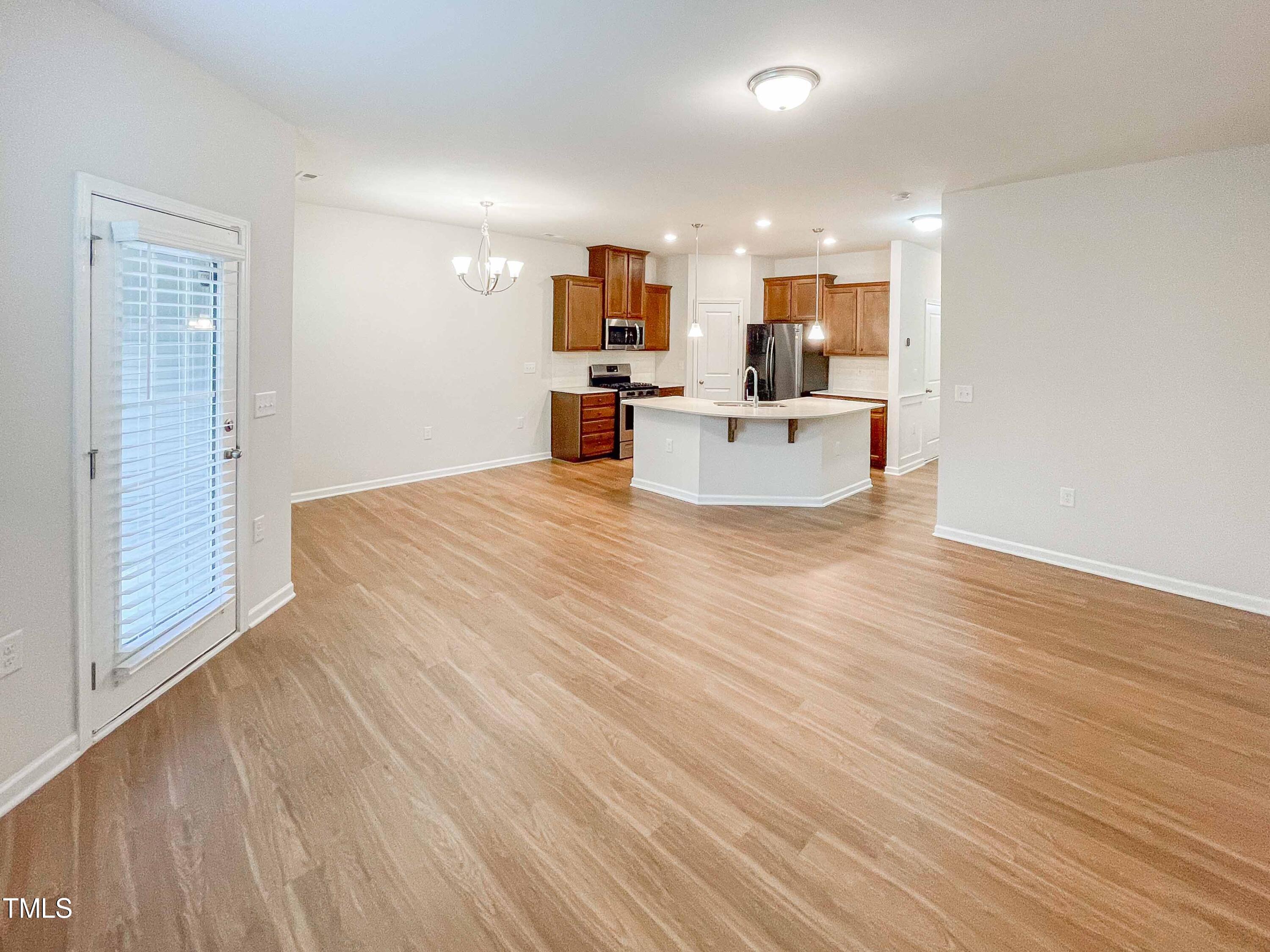 6027 Beale Loop Raleigh, NC 27616 - Photo 6 of 21 a view of large kitchen with wooden floor and stainless steel appliances