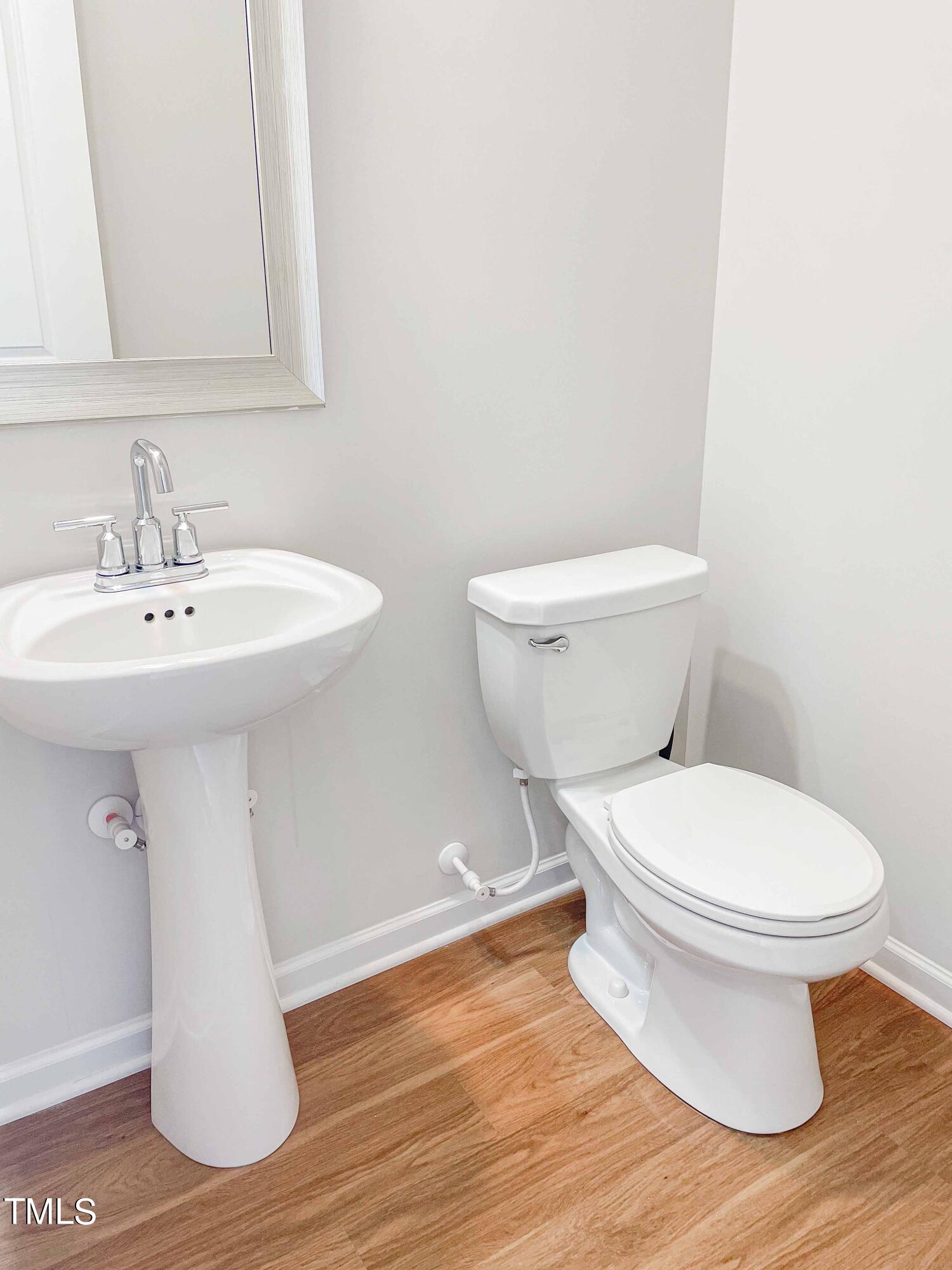 6027 Beale Loop Raleigh, NC 27616 - Photo 8 of 21 a bathroom with a sink and a toilet