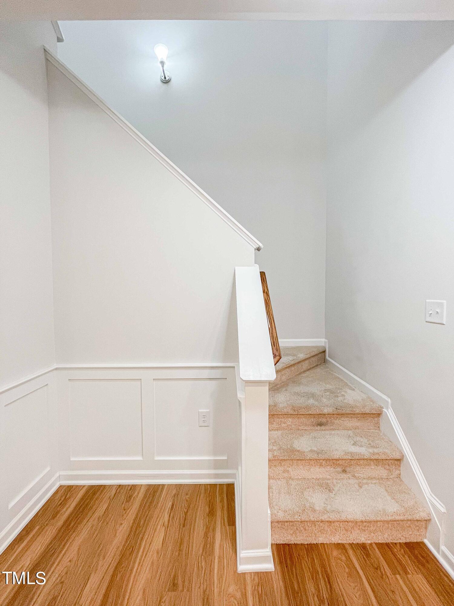 6027 Beale Loop Raleigh, NC 27616 - Photo 9 of 21 a view of a room with wooden floor and staircase