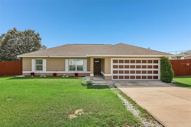 a front view of a house with a garden and patio