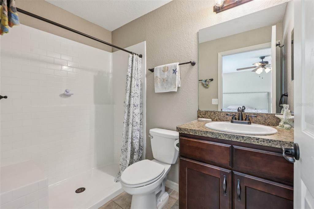 176 Juniper Loop Circle Ocala, FL 34480 - Photo 11 of 21 a bathroom with a granite countertop sink toilet and shower