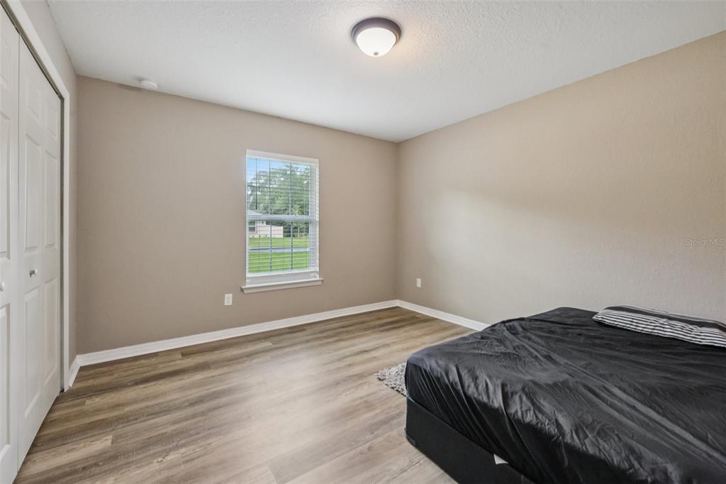 176 Juniper Loop Circle Ocala, FL 34480 - Photo 15 of 21 a bedroom with a bed and a window