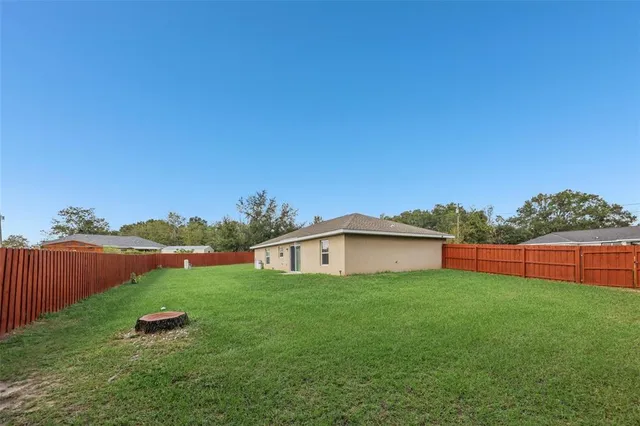 a backyard of a house with table and chairs