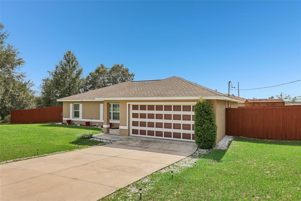 176 Juniper Loop Circle Ocala, FL 34480 - Photo 2 of 21 a view of a house with a yard