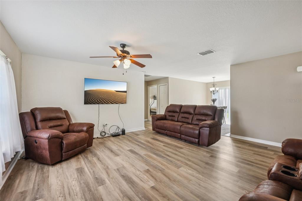 176 Juniper Loop Circle Ocala, FL 34480 - Photo 5 of 21 a living room with furniture and a wooden floor