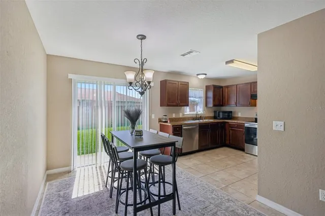 a kitchen with a table and chairs in it