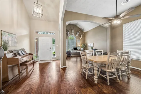 a view of a dining room with furniture and wooden floor