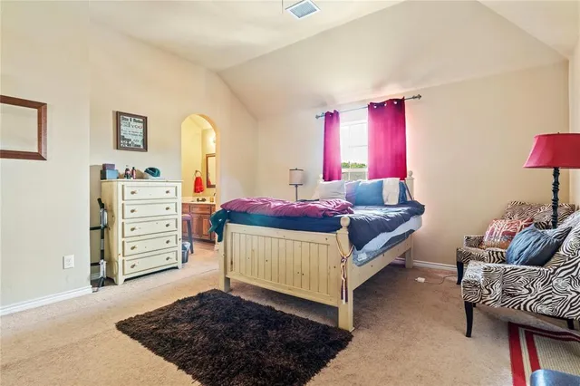 a bedroom with furniture and a dresser